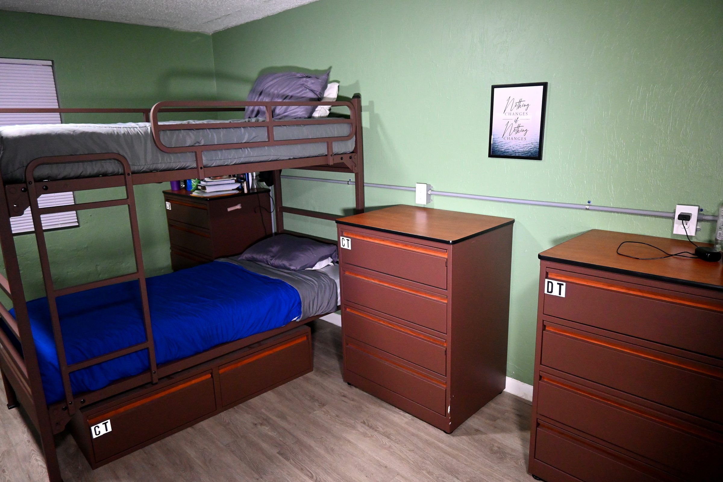 Resident room with bunk bed and dressers
