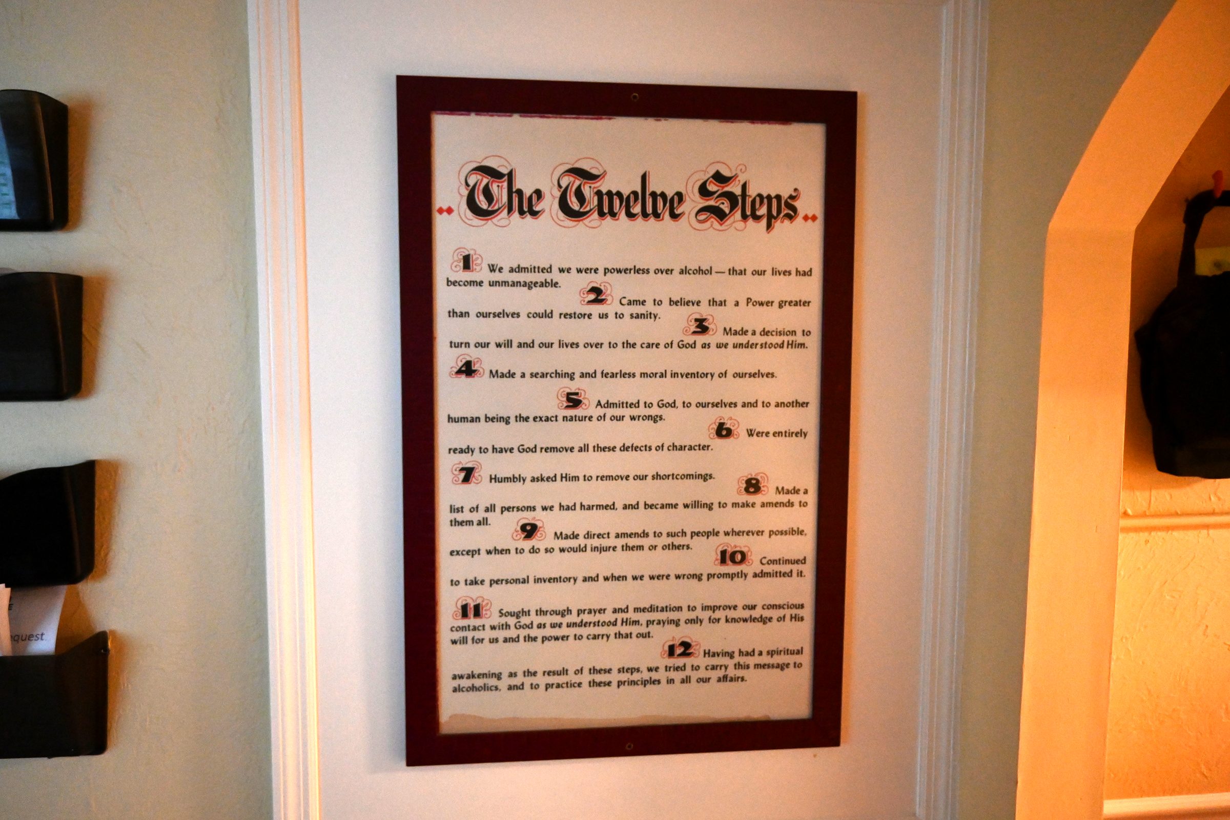 The Twelve Steps framed on the wall