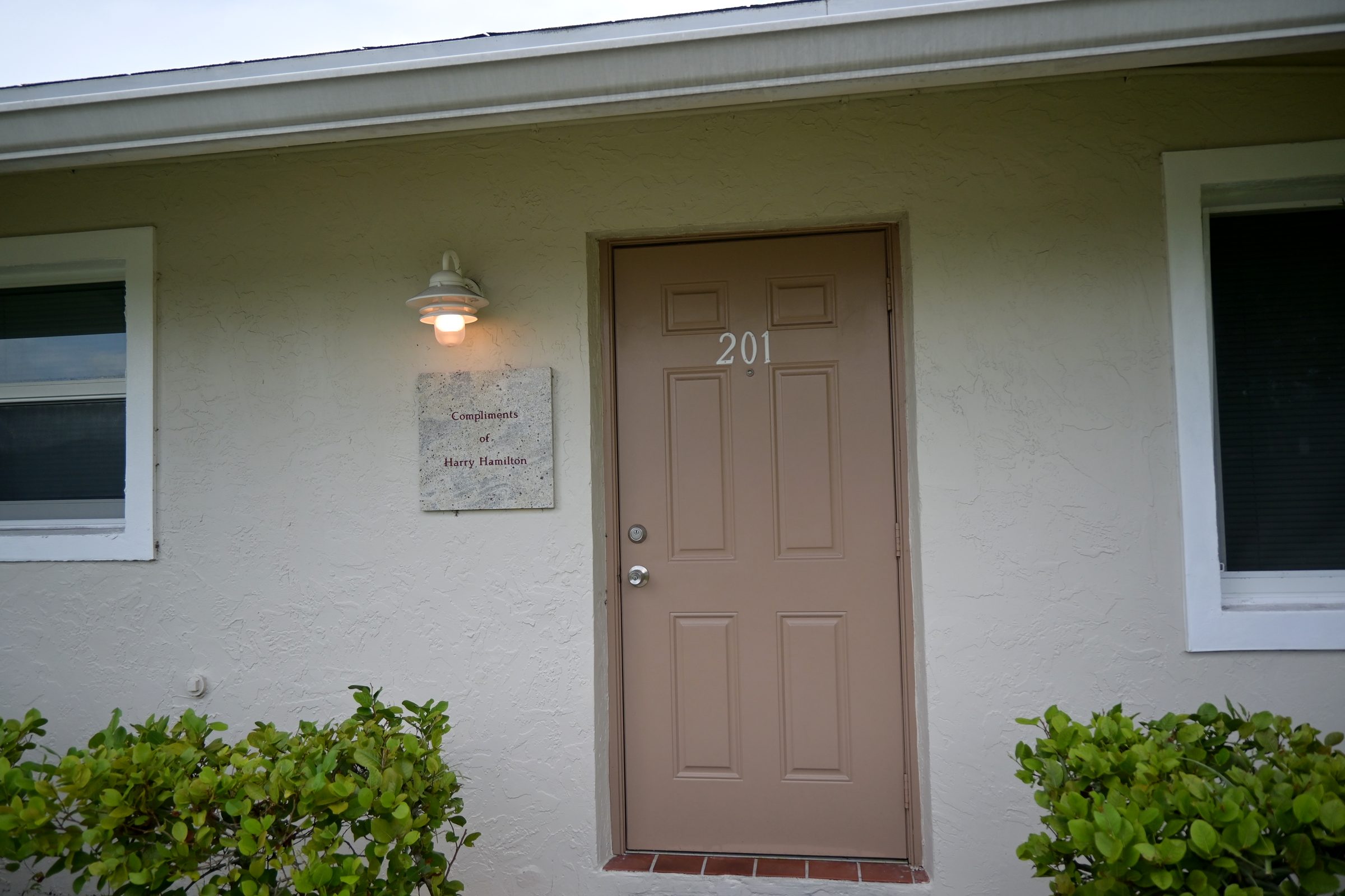 Unit 201 with a dedication plaque beside the door