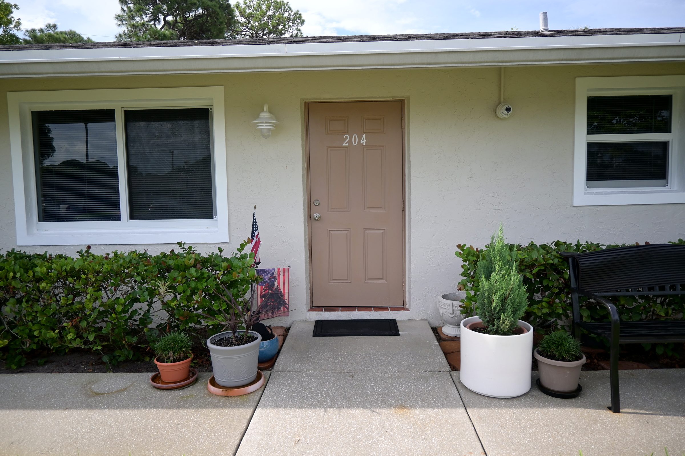 Unit 204 with potted plants by the door
